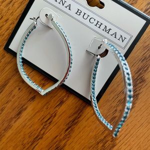 Silver drop shaped hoops with blue stones.